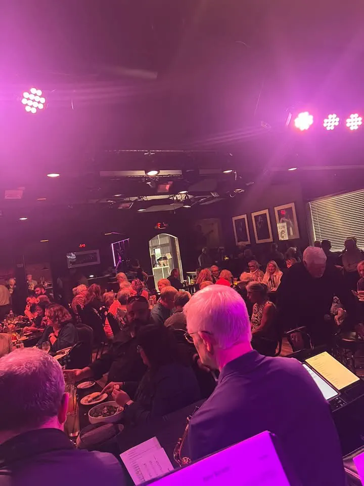 JoySwing musicians and audience under pink stage lights