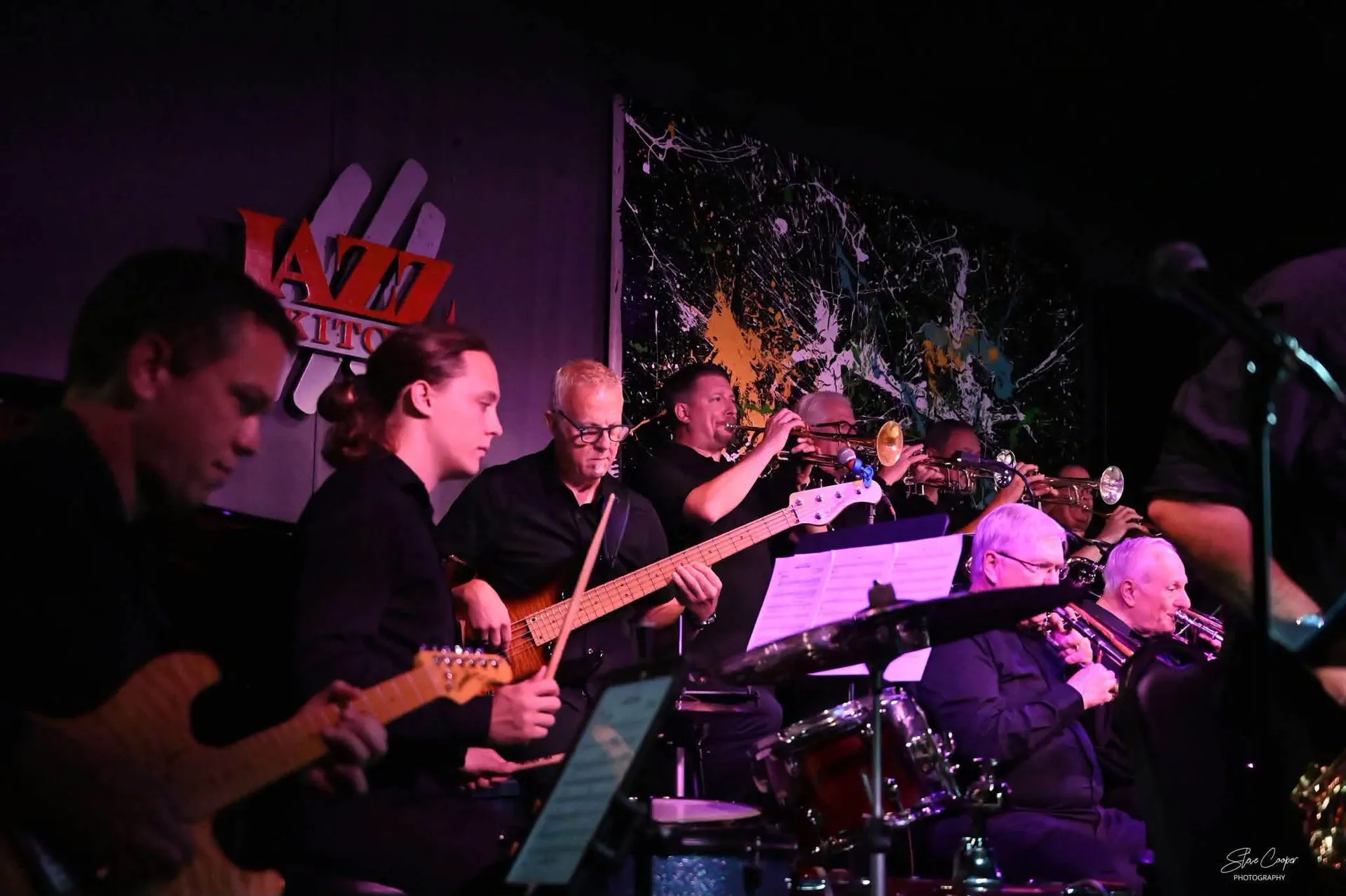 JoySwing rhythm section and horn players performing on stage